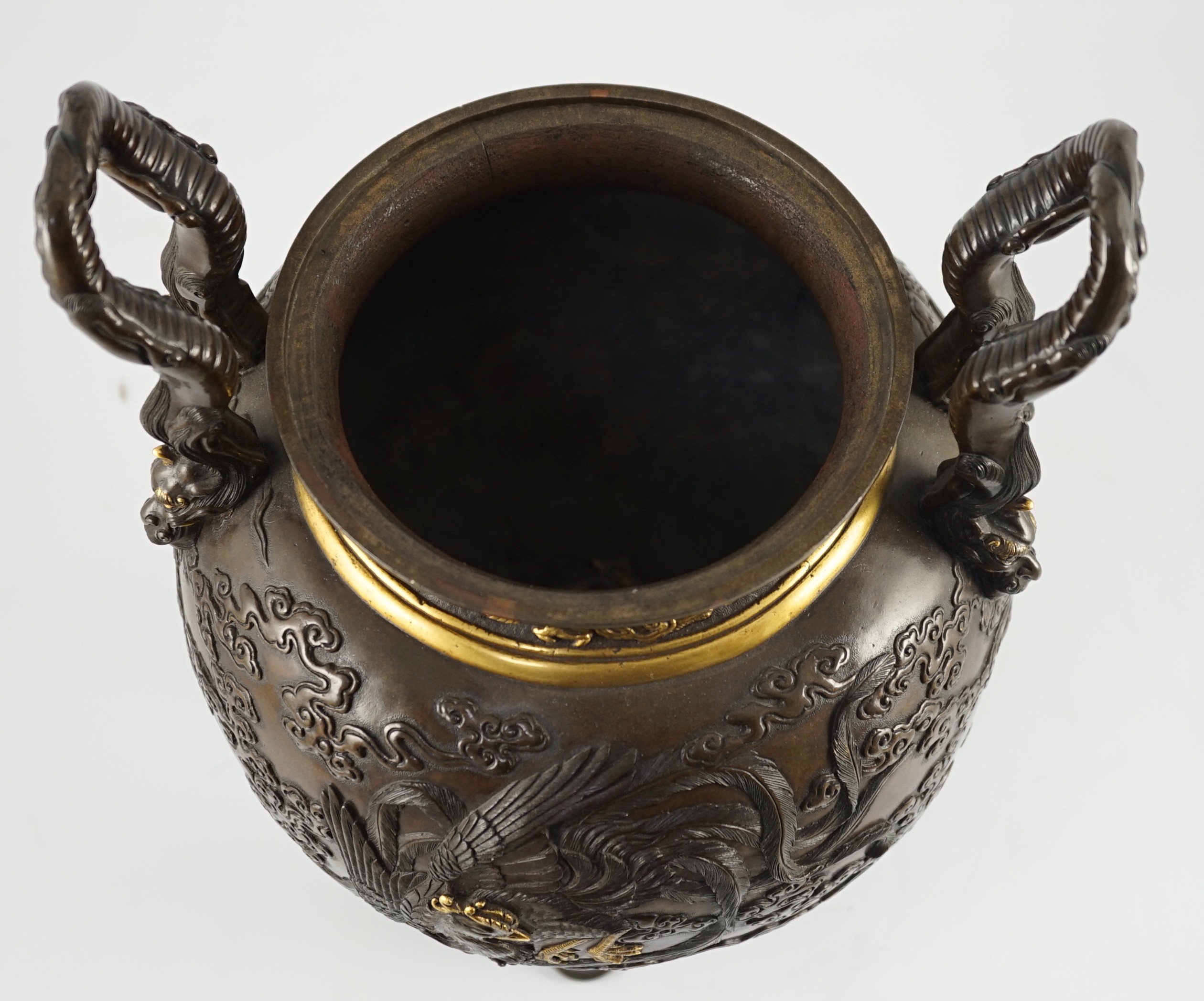 An impressive Japanese brown patinated and gilded bronze tripod koro and cover, by Miyao Eisuke, Meiji period, 42cm high, 23cm wide